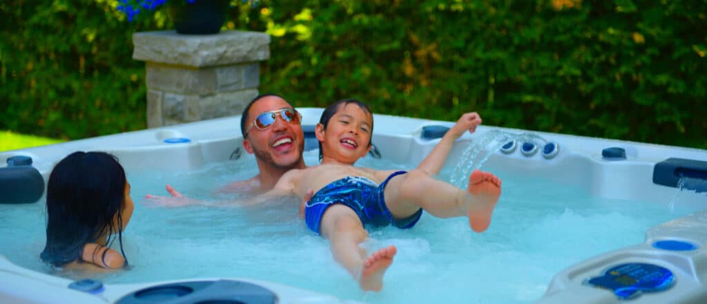 Family with children enjoying hydrotherapy in a hot tub