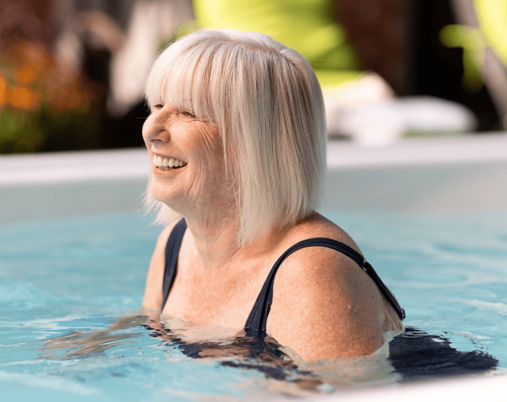 Old lady walking in hot tub