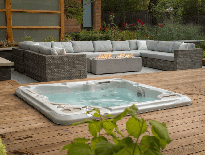 Luxury hot tub installed in the garden and encircled by a big sofa