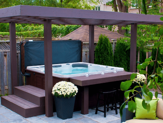 Hot tub running in the garden surrounded by flowers