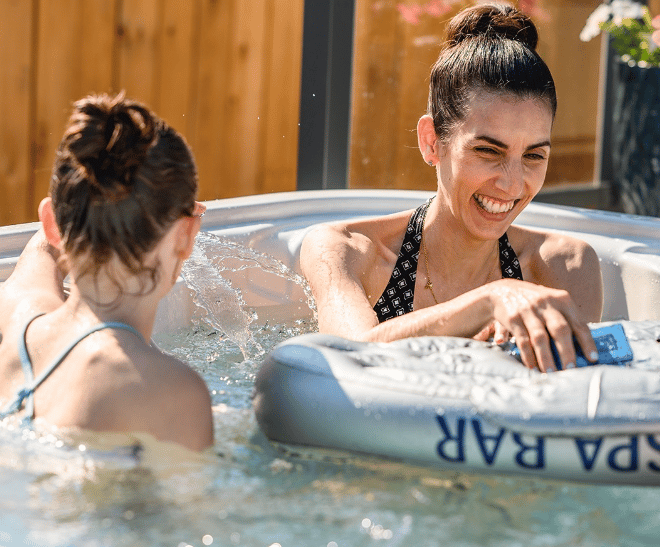 Two women enjoying their time in a hot tub